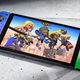 A Splatoon 3 special edition Switch OLED model sits on top of concrete.